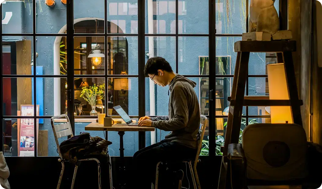 A job seeker working on a laptop in a cozy space